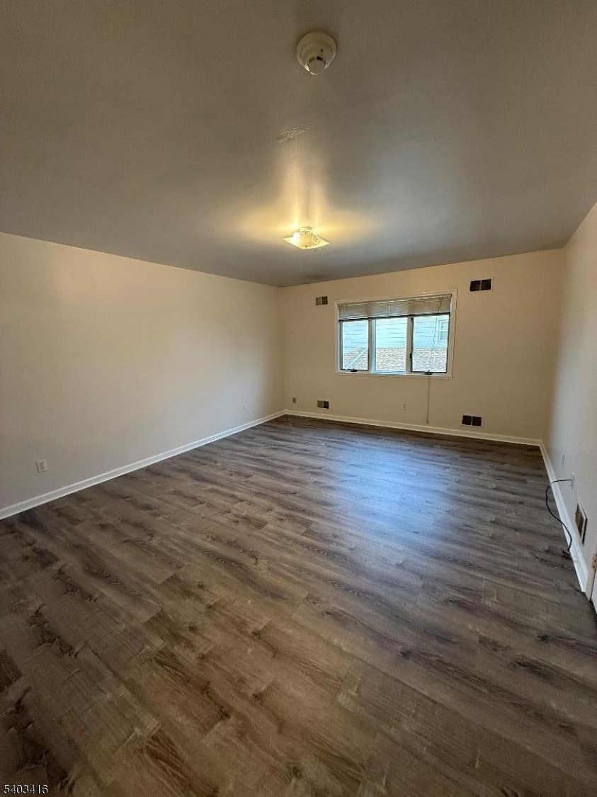 360 Ridge Road Lyndhurst, NJ 07071 - Photo 9 of 9 an empty room with wooden floor and windows