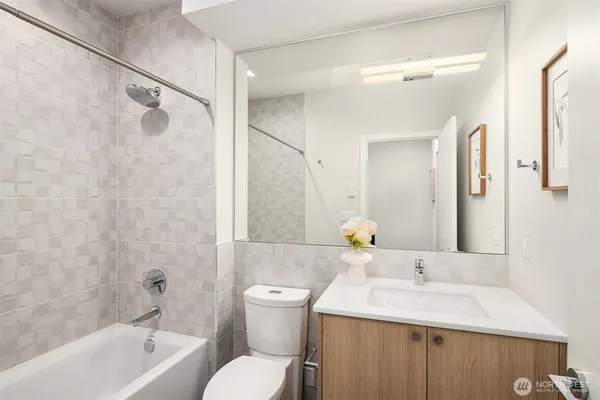 a bathroom with a sink toilet vanity and shower