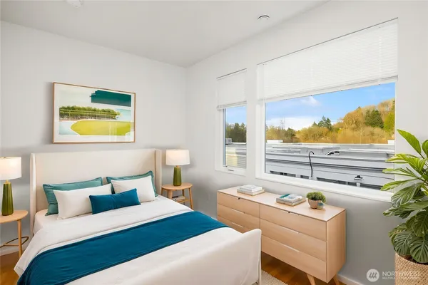 a bedroom with a bed and a painting on the wall