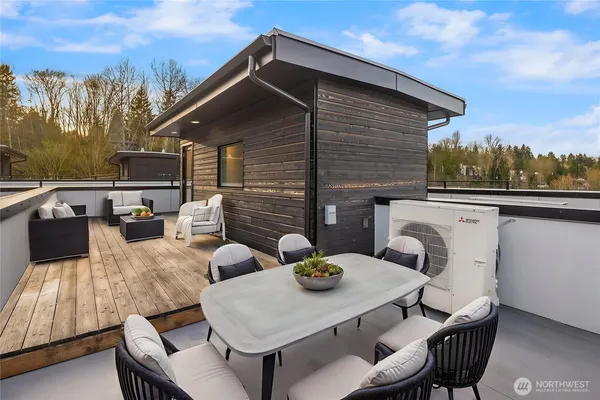 a view of a patio with table and chairs with wooden floor and fence