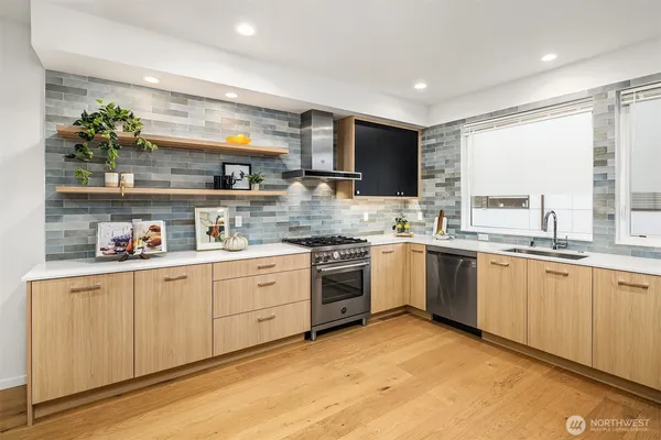 a kitchen with granite countertop a sink stainless steel appliances and cabinets
