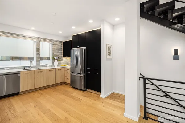 a kitchen with stainless steel appliances a refrigerator and a sink