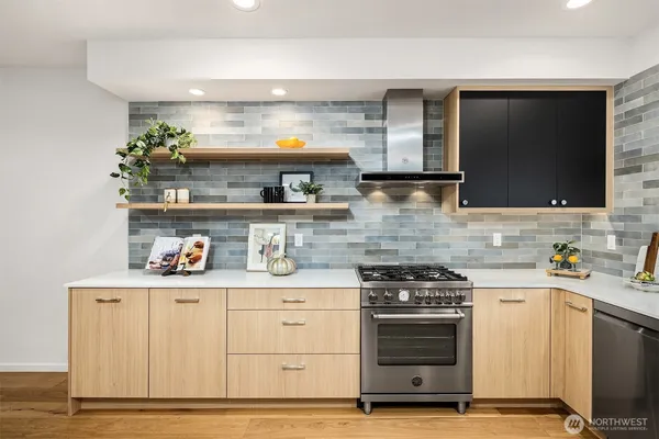 a kitchen with stainless steel appliances a stove and cabinets