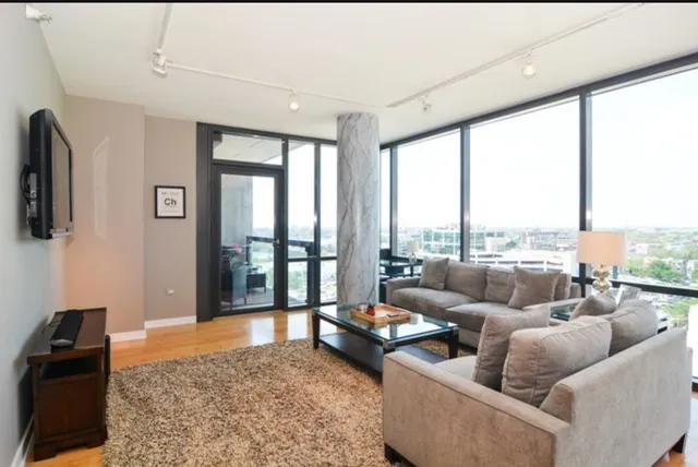 a living room with furniture and a floor to ceiling window