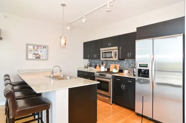 a kitchen with a sink stainless steel appliances and cabinets