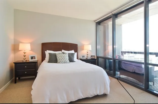 a bedroom with a bed and window