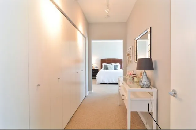 a bedroom with a bed and a lamp