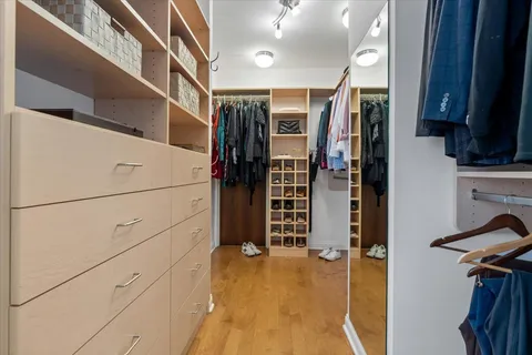 a view of walk in closet with clothes