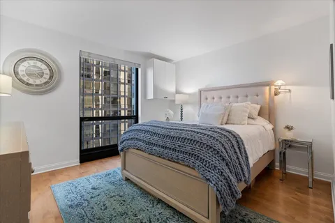 a spacious bedroom with a bed and a window in it