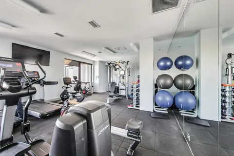 a living room with furniture a rug and a window