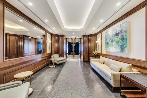 a lobby with furniture and a large window