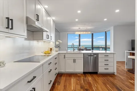 a kitchen with cabinets wooden floor and a sink