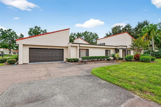 a front view of a house with yard and green space