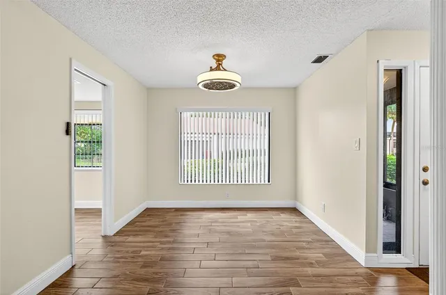 a view of an empty room and wooden floor