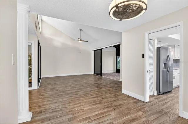 a view of an empty room with wooden floor