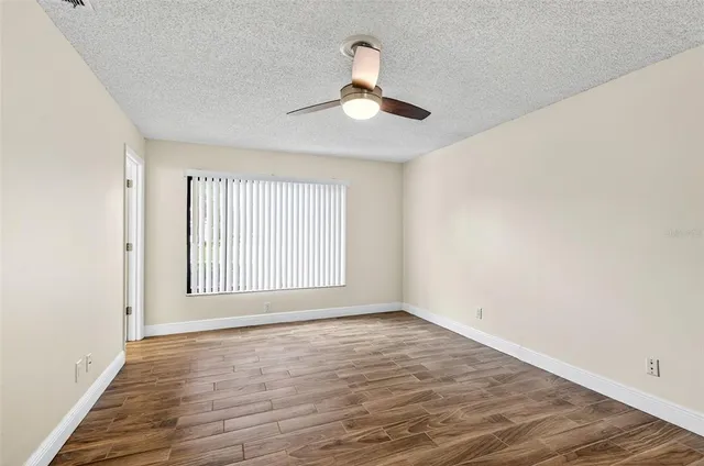 a view of livingroom with hardwood floor and ceiling fan