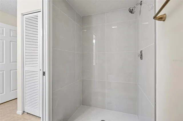 an empty room with wooden floor ceiling fan and windows