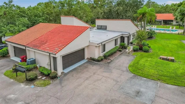 an aerial view of a house with a yard