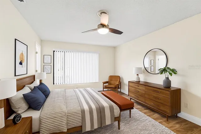 a bedroom with a bed a mirror and a window