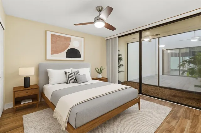 a bedroom with a large bed and a large mirror