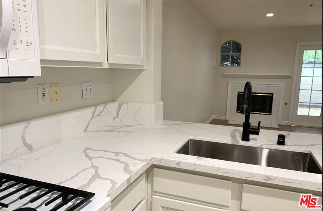 11209 Terra Vista Parkway, Unit C Rancho Cucamonga, CA 91730 - Photo 6 of 9 a kitchen with a sink and a stove top oven