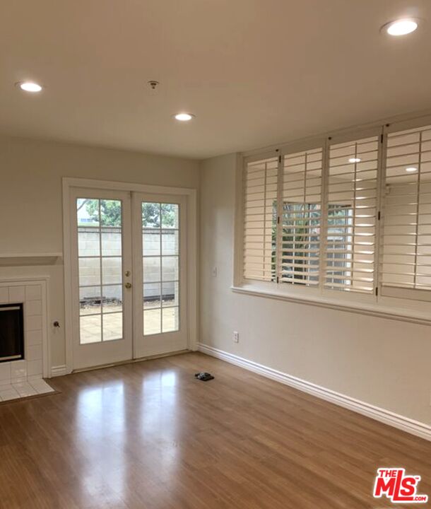 11209 Terra Vista Parkway, Unit C Rancho Cucamonga, CA 91730 - Photo 7 of 9 a view of an empty room with wooden floor and a window