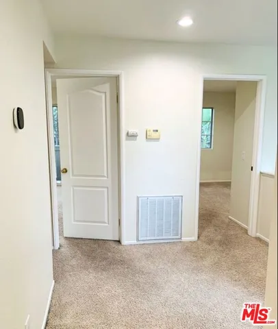 an empty room with mirror in it