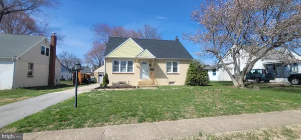 a view of a house with a yard and tree s