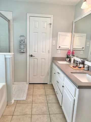 a bathroom with a sink a mirror and a shower