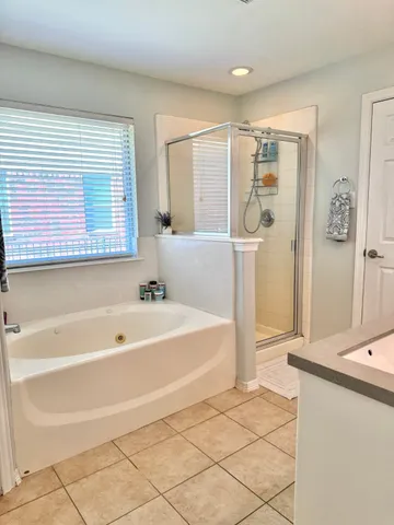 a spacious bathroom with a bathtub and a shower