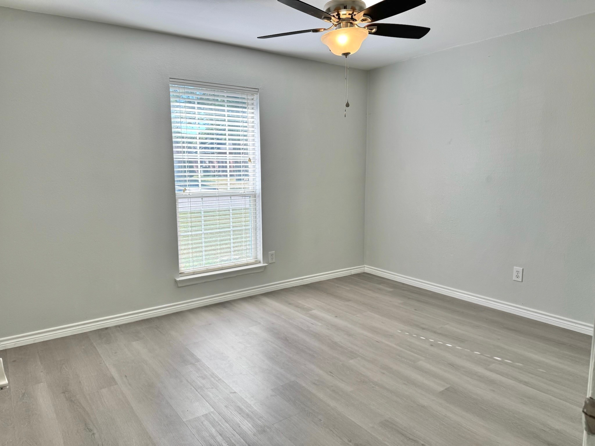 8603 Malardcrest Drive Humble, TX 77346 - Photo 17 of 21 a view of an empty room with wooden floor and a window