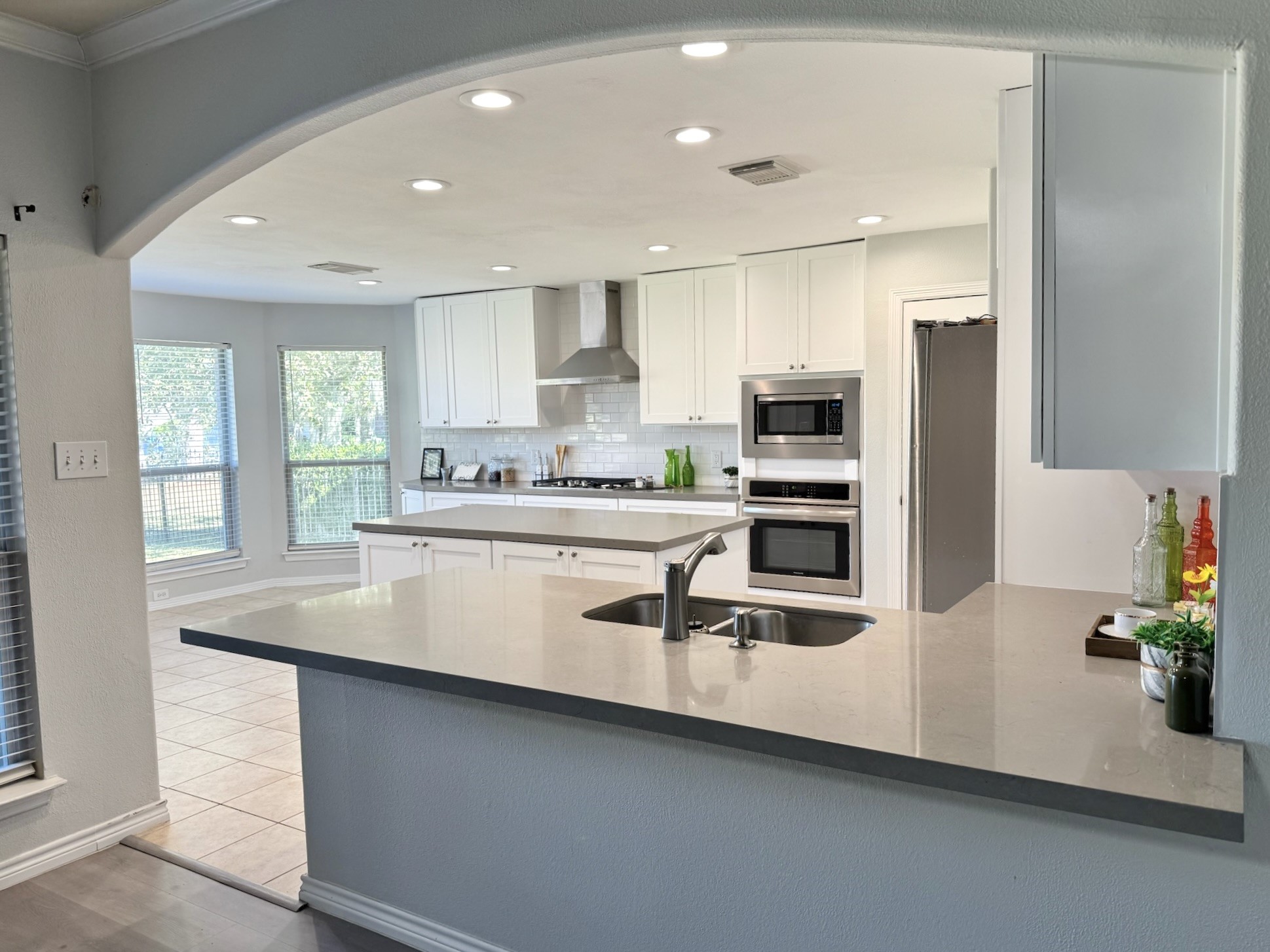 8603 Malardcrest Drive Humble, TX 77346 - Photo 3 of 21 a kitchen with stainless steel appliances a sink a stove a microwave and a refrigerator
