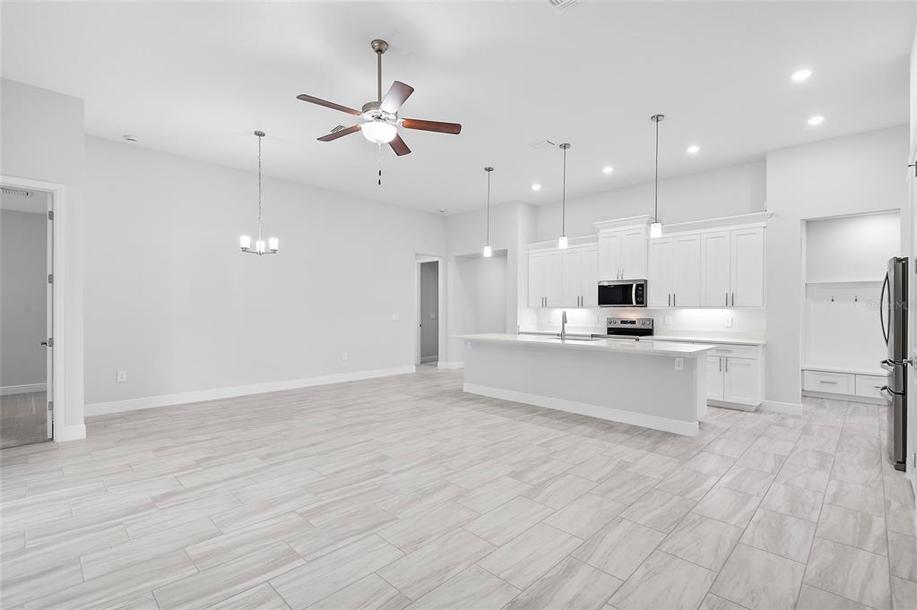 304 North Jungle Road Geneva, FL 32732 - Photo 20 of 49 a view of kitchen with kitchen island white cabinets and stainless steel appliances