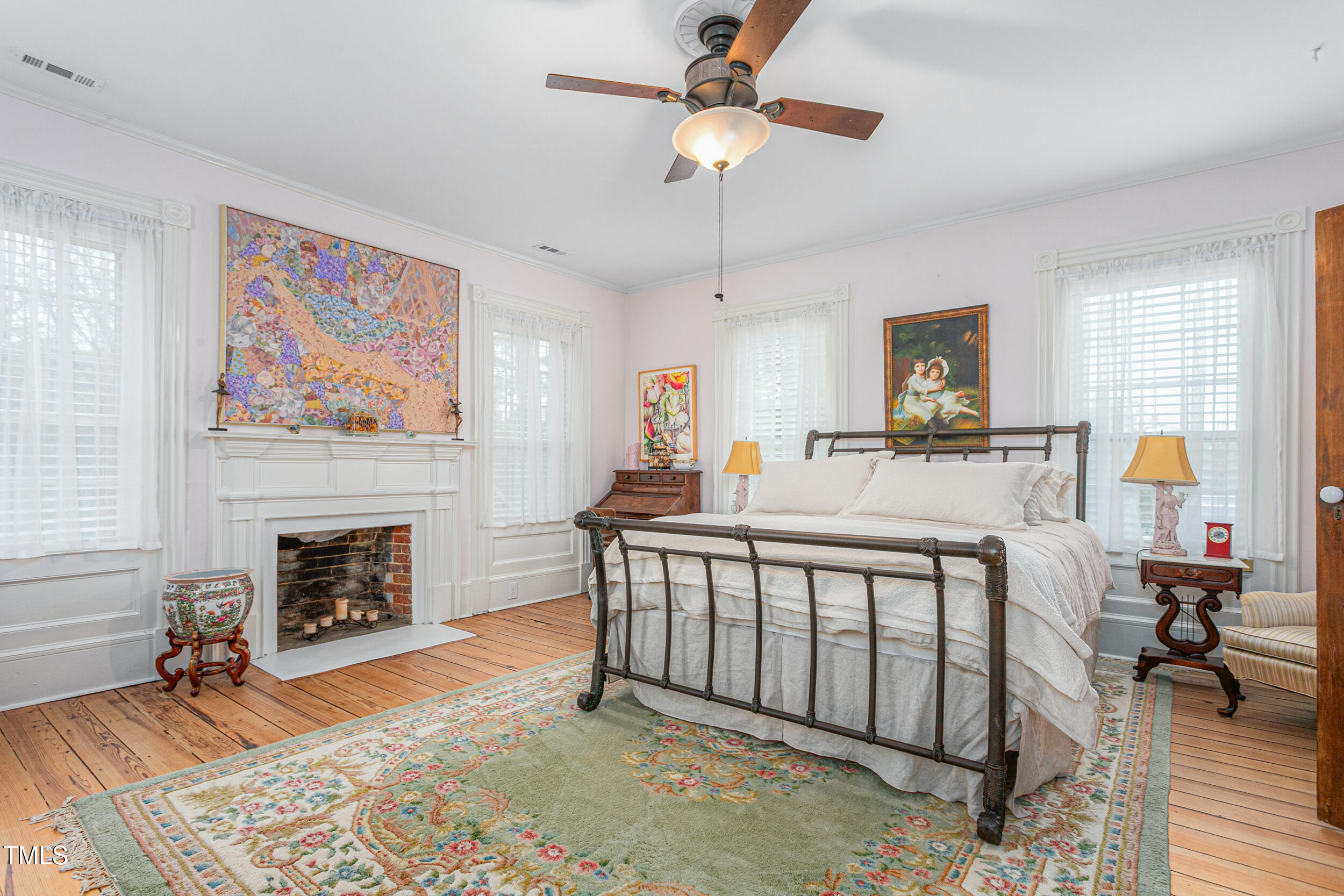 3542 Bason Road Mebane, NC 27302 - Photo 26 of 39 a bedroom with a bed and a fireplace