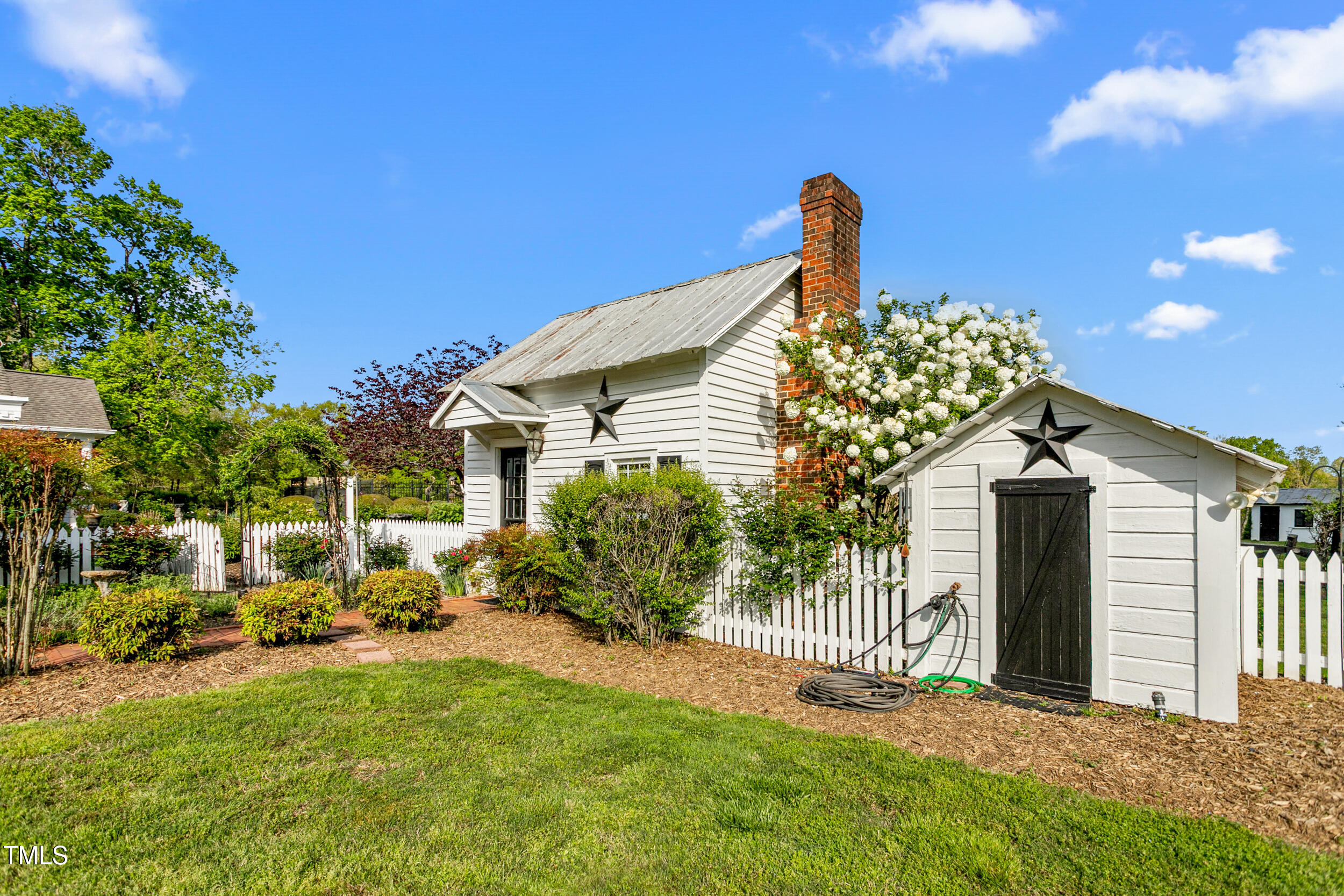 3542 Bason Road Mebane, NC 27302 - Photo 35 of 39 a front view of a house with a garden
