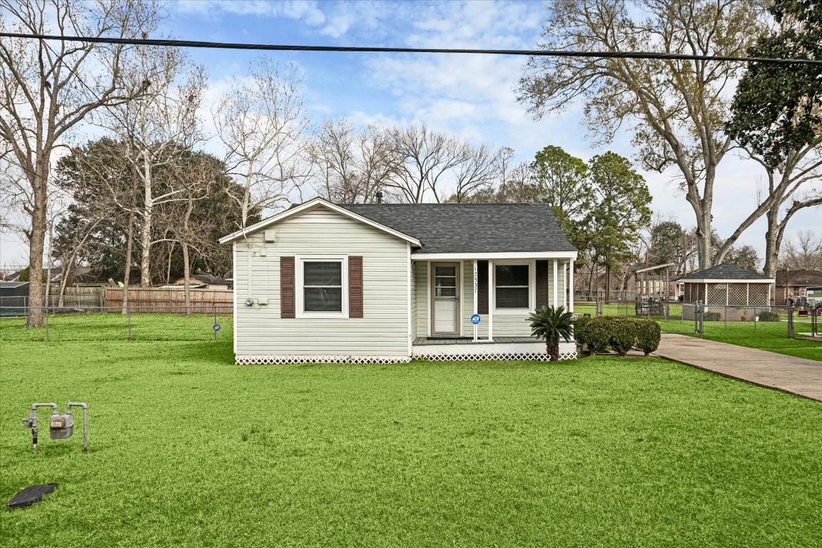 12537 Terrance is a charming small house with a cozy front porch and large screened-in back porch, set on a spacious, well-maintained lawn.