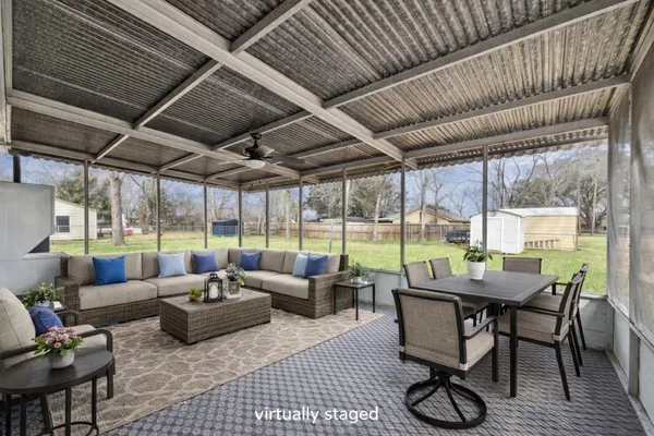 a dining room with furniture and a garden view
