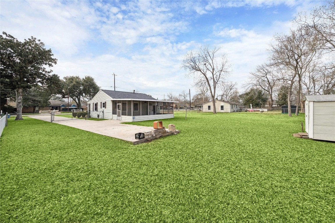 12537 Terrance Street Houston, TX 77085 - Photo 20 of 27 Charming single-story home with a spacious yard, featuring a concrete driveway and mature trees. The large yard is ideal for outdoor activities and relaxation. There is storage shed in the backyard for additional storage space.