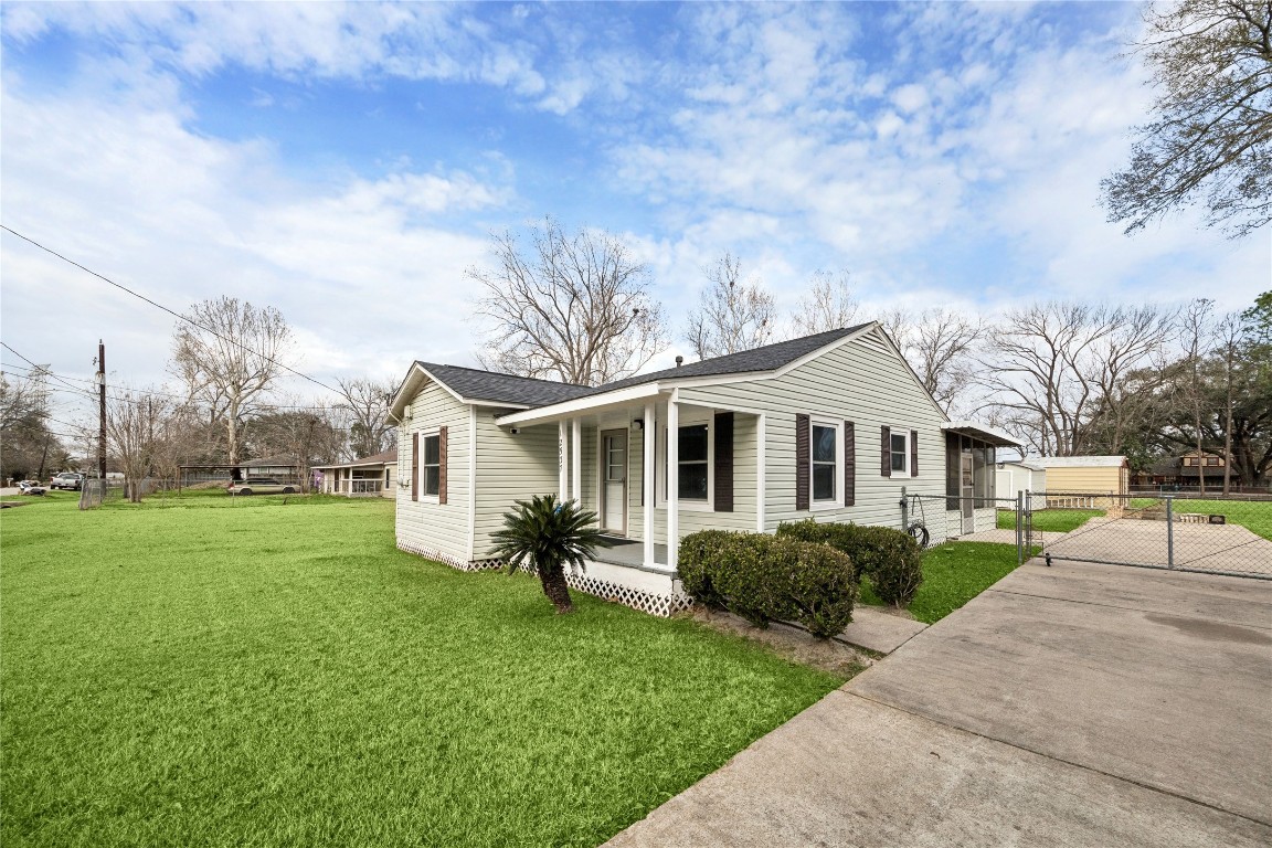 12537 Terrance Street Houston, TX 77085 - Photo 2 of 27 Charming single-story home with a well-maintained exterior, featuring light-colored siding and dark shutters. The property includes a spacious, grassy yard, a covered front porch, and a long driveway with a gated entrance. Ideal for those seeking a cozy, inviting space with ample outdoor area.