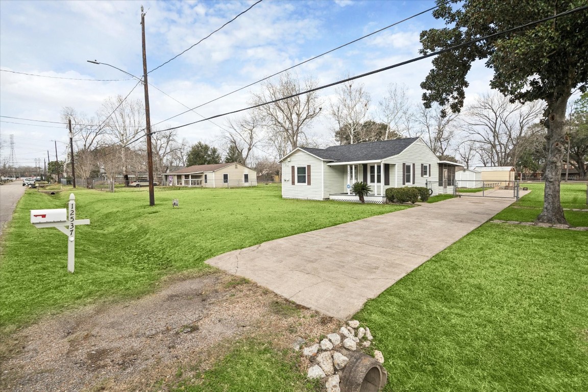 12537 Terrance Street Houston, TX 77085 - Photo 3 of 27 Charming single-story home with a well-maintained lawn and spacious driveway. The property features a cozy front porch, a screened-in back porch, and a spacious yard offering a welcoming atmosphere.