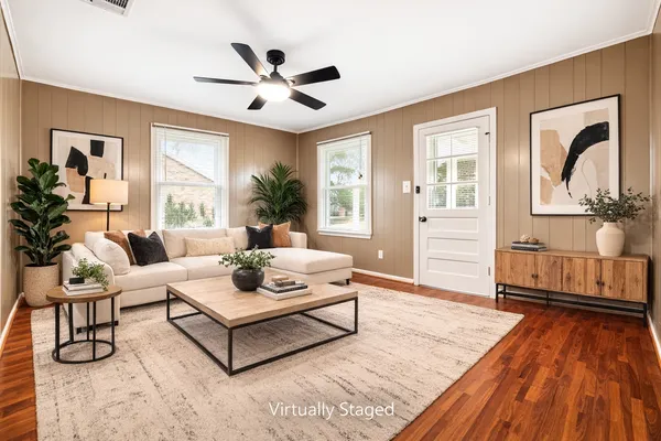 a living room with furniture and wooden floor
