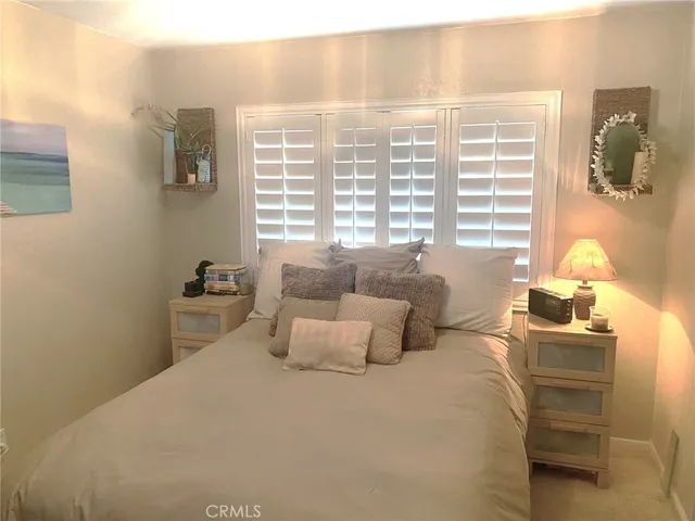 a bathroom with a bathtub shower sink mirror and toilet