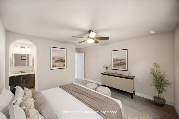 a living room with furniture and potted plant
