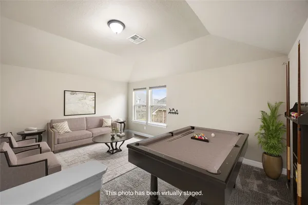 a view of a yard in front of a house with a large tree