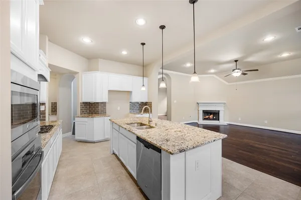 a large kitchen with kitchen island a dining table and chairs