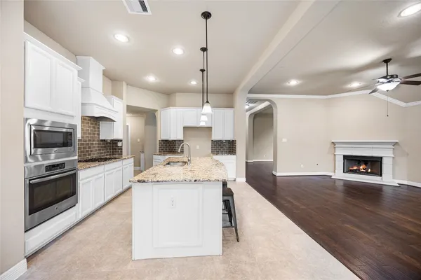 a kitchen with a table chairs stove and kitchen view