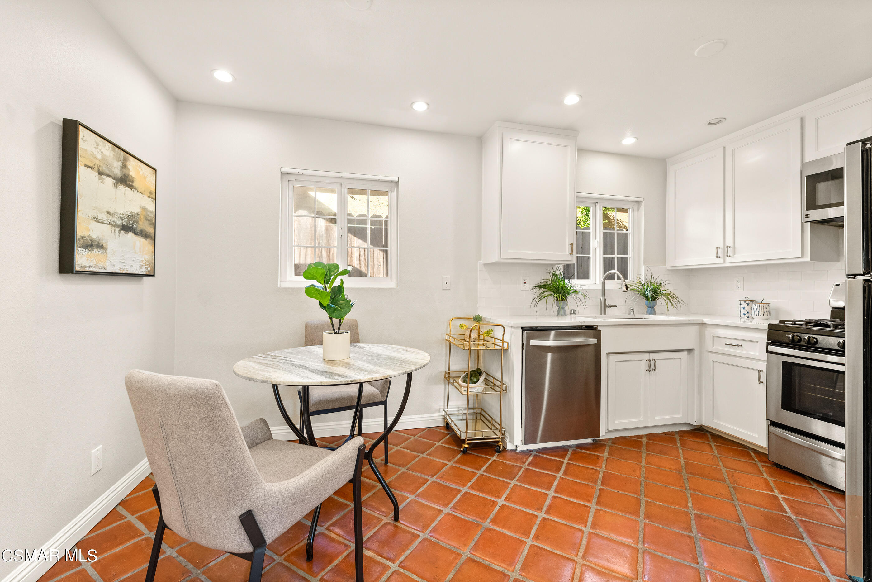 608 Hodencamp Road Thousand Oaks, CA 91360 - Photo 3 of 24 a kitchen with a cabinets appliances and a dining table