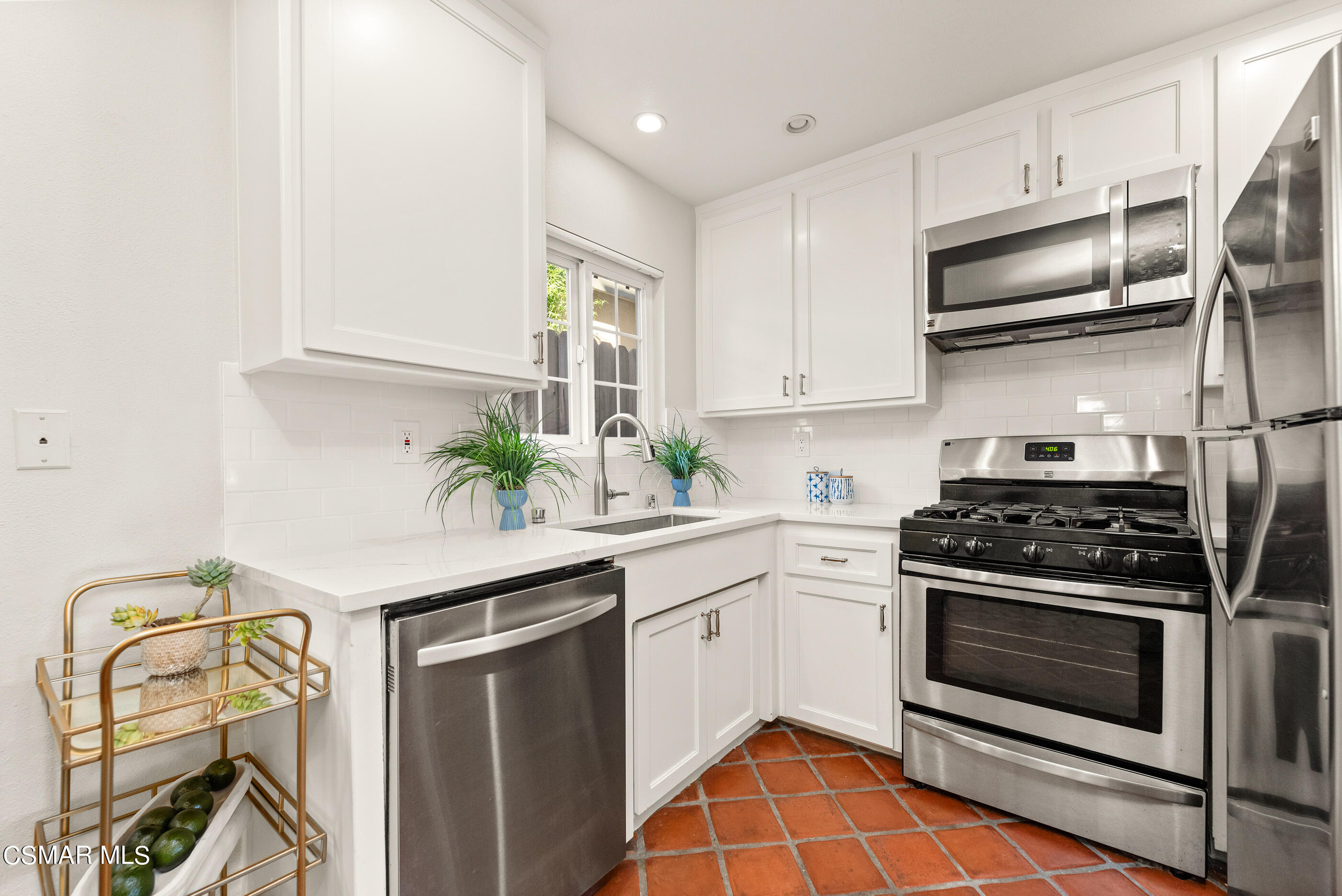 608 Hodencamp Road Thousand Oaks, CA 91360 - Photo 9 of 24 a kitchen with stainless steel appliances granite countertop a stove and a microwave
