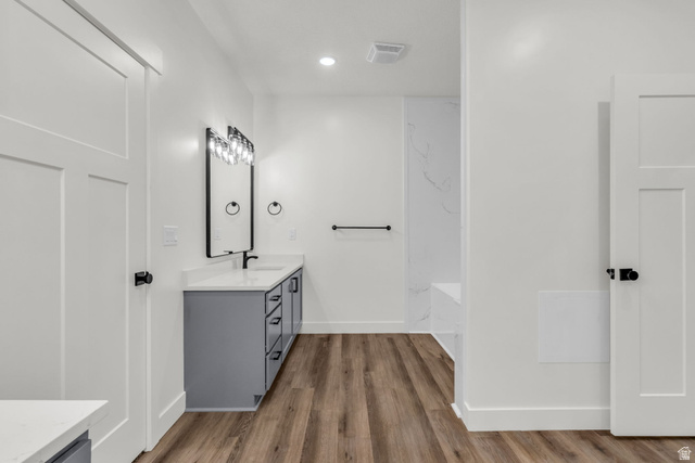520 East 450th Street North Delta, UT 84624 - Photo 24 of 48 Full bathroom with double vanity, dark wood-style floors, recessed lighting, and a bathtub