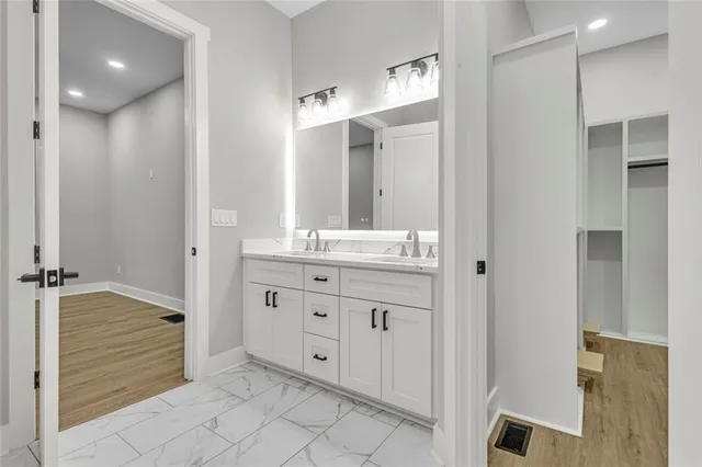 a bathroom with a granite countertop sink mirror and shower